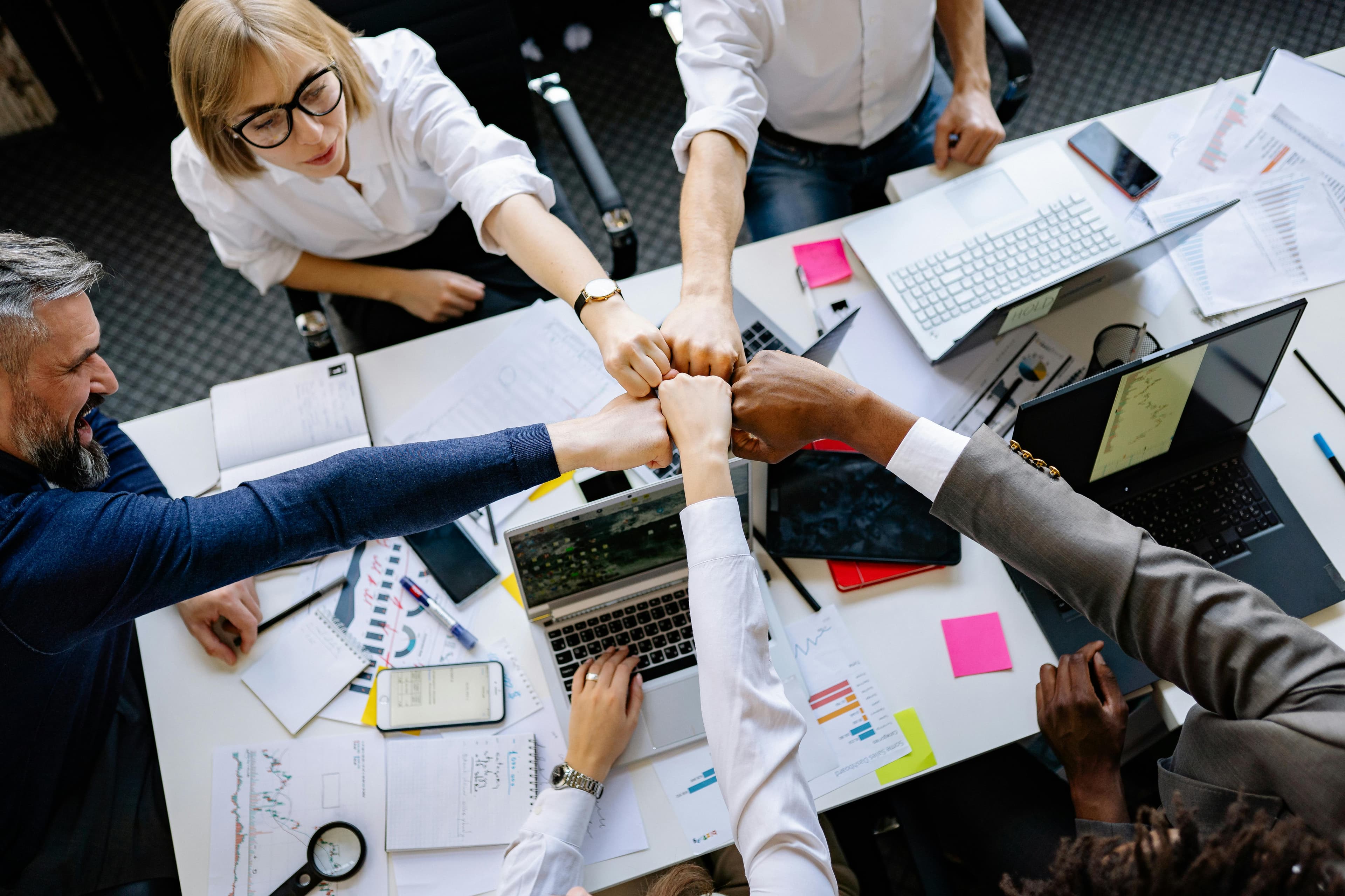 A diverse team of professionals in a modern office, collaborating on a project about financial strategy.